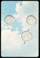 Parchutes with paratroopers in the air