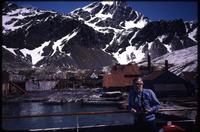Jack Child on dock at Grytviken station with mountains in background