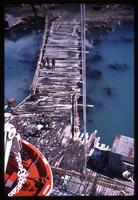 Aerial view of television crew, bagpipe player, and Grytviken dock from World Discoverer