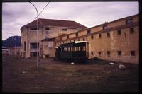 View of dilapidated jail and abandoned traincar  