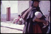 Bolivian woman breastfeeding child in Tiahuanaco