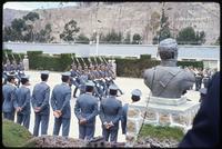 View of military personnel marching and rear view of statue