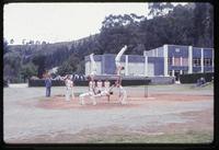 View of gymnasts practicing on field at military academy
