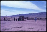 View of tourists observing structure at Tiahuanaco site