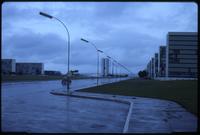 View of rainy road and surrounding buildings in Brasilia