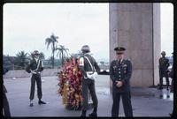 Jack Child at World War II monument with guards and wreath in background