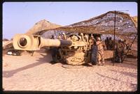 American soldiers operating a Howitzer with a 155mm artillery piece during the Gulf War, Saudi Arabia