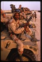 American soldiers sitting atop military vehicles during the Gulf War, Saudi Arabia