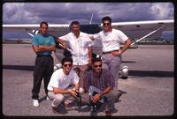 Brothers to the Rescue members posing in an airfield in front of an airplane, Miami, Florida