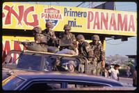 American soldiers with the 82nd Airborne Division ride in a military vehicle during the United States Invasion of Panama, Panama City, Panama