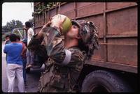 An American soldier drinks from a coconut during the United States Invasion of Panama, Santiago, Panama