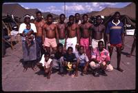 A group of Haitian refugees posing for a picture while awaiting medical examinations at the Guantanamo Bay Naval Base