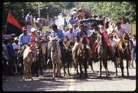 A parade with men riding on horseback at a Sandinista National Union of Farmers and Ranchers Rally, Managua, Nicaragua