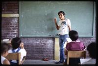 A Cuban math teacher explains an exercise to his class at a public school, Nicaragua