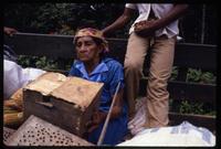 A Miskito woman sitting in a truck and holding a box during the return to their homeland along the Coco River from the former resettlement camp in the Columbus neighborhood of Tasba Pri, Nicaragua