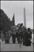 Demonstrators in a mock funeral procession protesting the lack of American aid to Biafra pausing by the Lincoln Memorial Reflecting Pool during a rally, 12 October 1968
