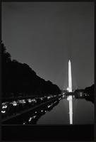 A line of people holding candles along the length of the north side of the Reflecting Pool during a Biafra candlelight vigil between the Lincoln Memorial and the Washington Monument, 25 October 1968