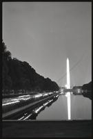 Alternate long exposure of a line of people gathered along the north side of the Reflecting Pool during a Biafra candlelight vigil between the Lincoln Memorial and the Washington Monument, 25 October 1968