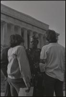 A group converses during a Biafra rally at the base of the Lincoln Memorial, 25 October 1968
