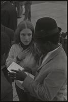 A woman listens to a man at a Biafra rally at the Lincoln Memorial, 25 October 1968