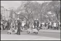 Anti-war demonstrators cross the street at DuPont Circle with police in foreground, 26 October 1968