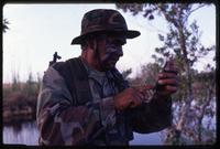 A man works with an electronic device during the anti-Castro Alpha 66 training, Florida