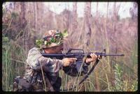 A volunteer taking aim with a gun during an Alpha 66 training exercise, Florida