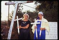 Women hold crosses in remembrance of the dead at a demonstration against United States foreign policy outside the American Embassy, Managua, Nicaragua