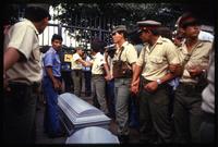 Guards surround and protect the caskets of dead crew members by the American Embassy gates, Managua, Nicaragua