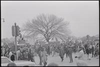Alternate view of a mass of protesters gathered to demonstrate against Nixon's inauguration and the Vietnam War on the Mall at the counter-inaugural tent on the intersection of 15th St SW and Independence Ave SW, 19 January 1969