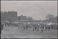Alternate view of a protest march led by GIs and veterans sets out from 15th St SW and Independence Ave SW across the grounds of the Washington Monument. Protesters gathered to demonstrate against Nixon's inauguration and the Vietnam War, 19 January 1969