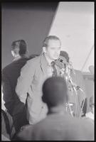A speaker, possibly David Dellinger, moderates a rally against Nixon's inauguration and the Vietnam War, 19 January 1969