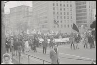 Alternate view of a march led by the Southern Students Organizing Committee passing down Pennsylvania Ave NW, protesting Nixon's inauguration and the Vietnam War, 19 January 1969