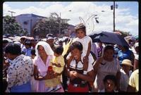 Two women carrying children dressed as angels while attending a Good Friday procession, Managua, Nicaragua