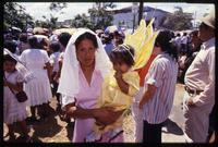 A child, dressed as an angel, is carried by a women attending a Good Friday procession, Managua, Nicaragua