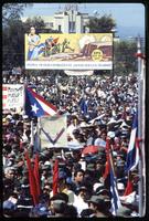 A billboard overlooks a political rally commemorating the fifth anniversary of the Nicaraguan Revolution and Sandinista control of the government, Managua, Nicaragua