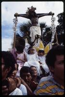 Men carry a crucifix and children dressed as angels through a religious procession, Managua, Nicaragua