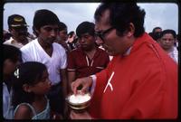 People wait for Bishop Bosco Vivas to give them Sacramental bread during a religious service, Managua, Nicaragua