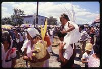 Children in religious costumes are carried on people's soldiers for the Good Friday procession, Managua, Nicaragua