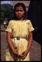 A young girl wearing a yellow dress for a Good Friday procession, Managua, Nicaragua