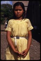 A young girl wearing a yellow dress to attend a Good Friday procession, Managua, Nicaragua