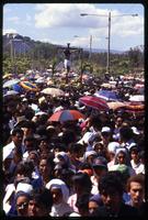 A crucifix looms over a crowd of Good Friday procession participants, Managua, Nicaragua