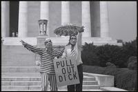 Figures dressed as Nixon and Kissinger gesturing to passersby from the steps of the Lincoln Memorial, holding a sign ("Pull out, Dick") at a masquerade during the Vietnam Veterans Against the War demonstration, 04 July 1974