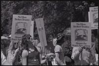 Close-up of protesters with signs ("No more broken treaties, Honor the Peace Agreement") during a rally to impeach Nixon along the National Mall, 29 May 1974
