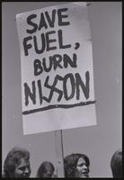 Close-up of a sign ("Save fuel, burn Nixon" [the x in Nixon is replaced by a swastika]) at a rally to impeach Nixon along the National Mall, 29 May 1974