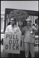 Figures of Nixon and Kissinger pose near demonstrators at the Lincoln Memorial at a masquerade during the Vietnam Veterans Against the War demonstration, 04 July 1974