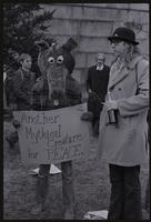 An alternate view of a protester against Richard Nixon's second inauguration wearing an animal costume and holding a sign that reads "Another Mythical Creature for PEACE," 20 January 1973