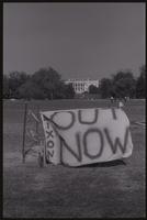 A banner reading "Nixon Out Now" is displayed on the Ellipse, with a clear view of the White House in the background, 27 October 1973
