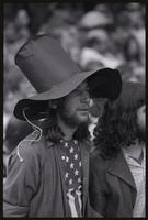 A young man wears a top hat made from construction paper during the Vietnam War Out Now demonstration, 24 April 1971