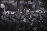 Alternate view of demonstrators in the May Day protests raise their fists in the air in front of a line of police officers, 03 May 1971